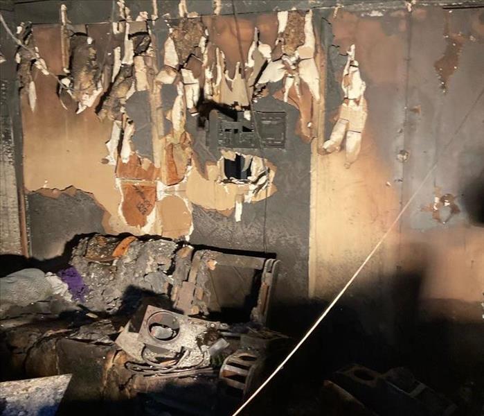 Burned up room in an apartment fire. furniture and walls are scorched.