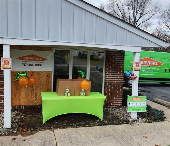 Front of SERVPRO office, decorated table and boxes for non perishable food donations