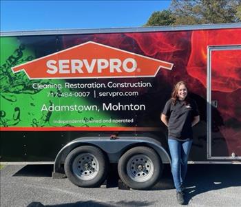 SERVPRO woman stands in front of a SERVPRO trailer